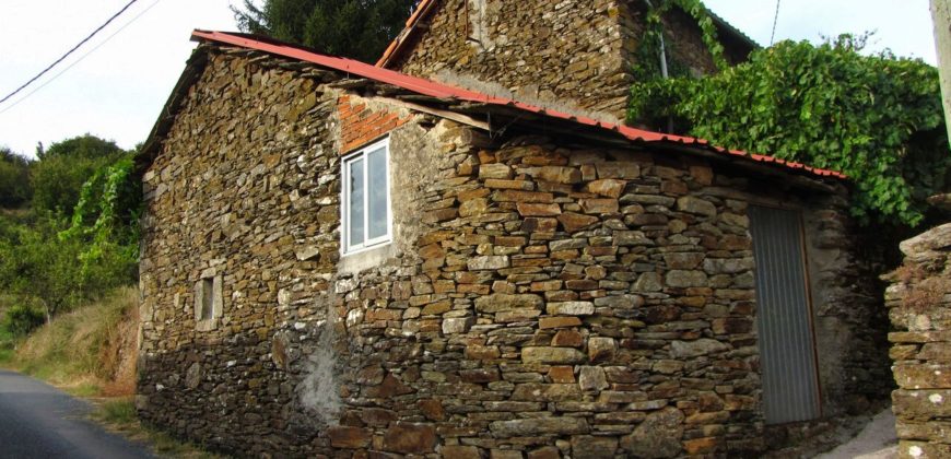 Traditional stone house with courtyard on the banks of the river Miño